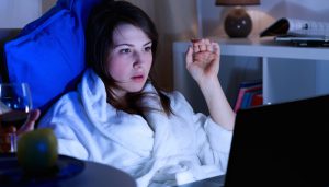 Pretty girl spending night alone with laptop